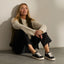 Lay Day Lite black sneakers with toes facing forward on a seated woman in casual beach inspired style