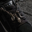 Close up of Lay Day Dawn black sneaker facing lower right showing the laces tongue and decorative charms