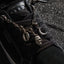 Close up of Lay Day Dawn black sneaker facing lower right showing the laces tongue and decorative charms