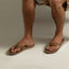 Leather Offshore sandals on adult male feet facing forward, showcasing soft-rebound cushioning and anatomical arch support.