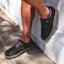Verano men's black suede shoe facing right, showing side and top view with cushioned midsole and rugged outsole.
