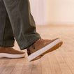 Side view of the right foot wearing Verano shoe in brown suede with white sole, showcasing lightweight comfort and grip.
