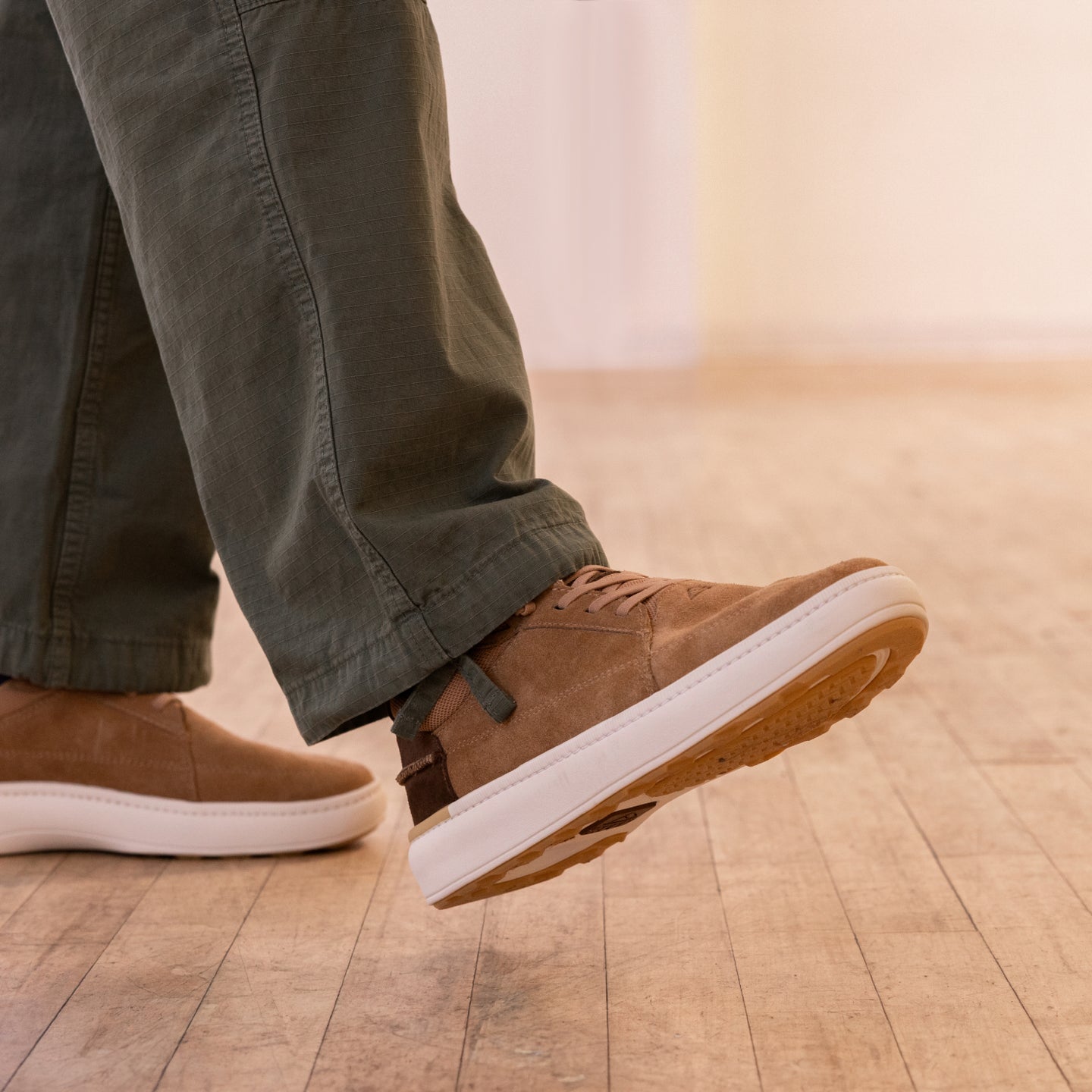 Side view of the right foot wearing Verano shoe in brown suede with white sole, showcasing lightweight comfort and grip.