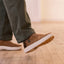 Side view of the right foot wearing Verano shoe in brown suede with white sole, showcasing lightweight comfort and grip.