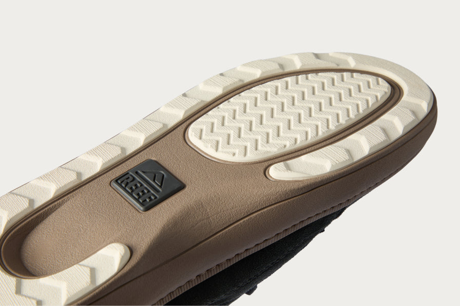 Close-up of the sole of a right REEF sandal showing textured outsole for durability and comfort on beach surfaces
