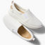 Pair of white Neptune Elyse slip-on sneakers for women showing top and right side, surf-inspired comfort footwear