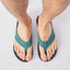 Top view of Nox men's black sandals with teal straps, showing front footbed and toe area, designed for beach comfort.