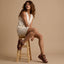 Woman seated on stool wearing Vista Higher Luna sandals facing right, showcasing soft-rebound cushioned sole and arch support.