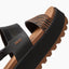 Close-up of the left side of the Water Vista Higher sandal showing black and brown textured straps with arch support and ridged sole