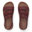 Top view of maroon REEF sandals with three straps and molded footbeds, designed for beach comfort and durability.
