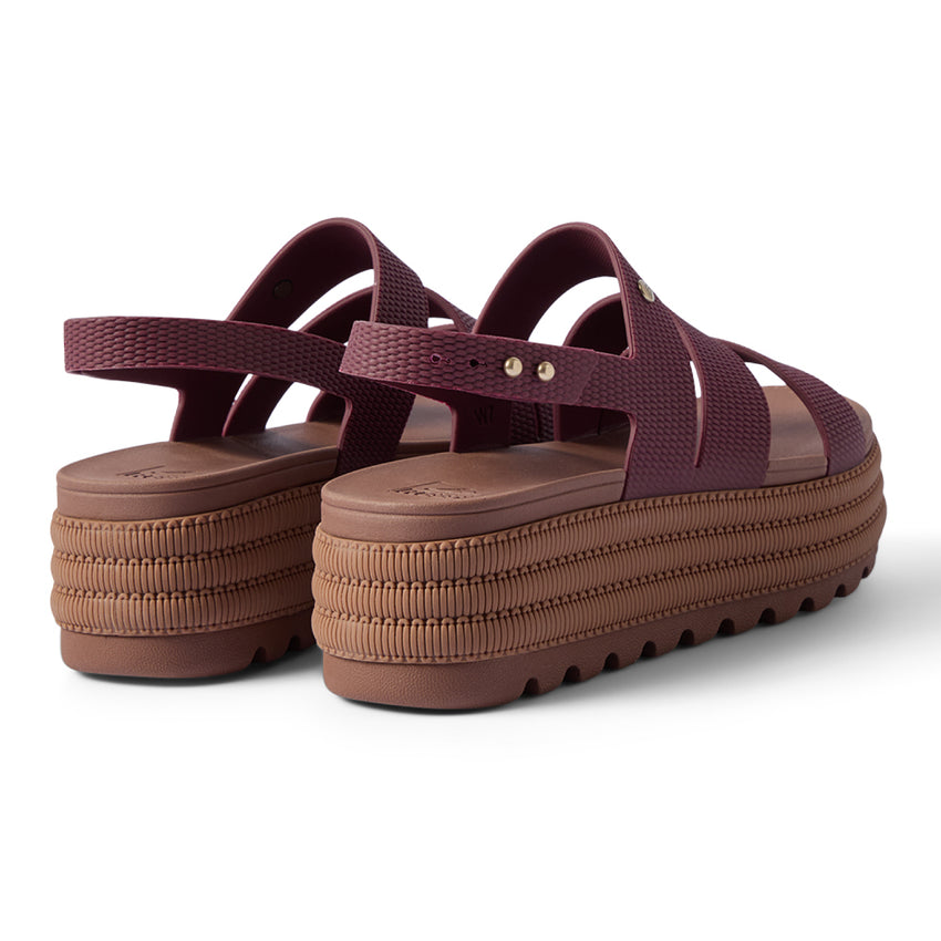 Pair of maroon platform sandals facing away, showing textured back straps and thick cushioned soles.