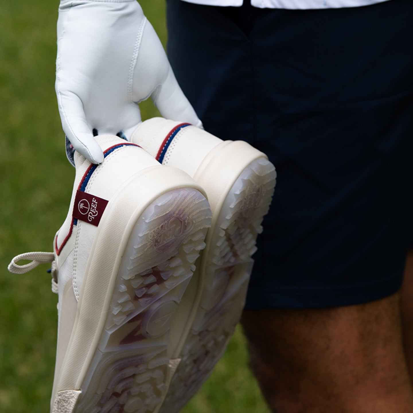 Palm X G-Papi white golf shoes close up with textured outsoles facing the camera