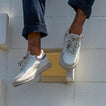 Palm X G-Papi white sneakers, one facing left and one facing forward, with cushioned soles