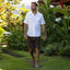 Man walking outdoors wearing Phantom Tradewind sandals facing forward, showcasing water-friendly, cushioned, tan footwear.