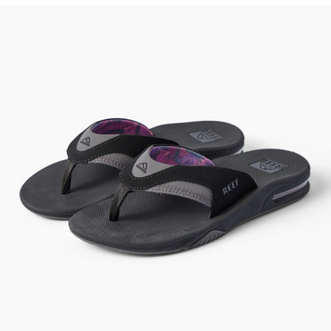 REEF Fanning black flip flops with toes facing left, cushioned footbeds and anatomical arch support