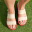 Top view of beige Water Vista Higher sandals on feet with red soles, showcasing soft-rebound cushioning and arch support.