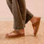 Vista Gabriella sandal facing right in a close-up side view showing buckle detail and suede strap on foot.