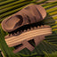 Pair of brown Water Vista Higher 2 sandals facing right, showing side and top views with platform sole on palm leaves.