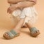 Front-facing Cushion Vista Hi sandals on feet with extra cushioning and arch support in a casual seated pose