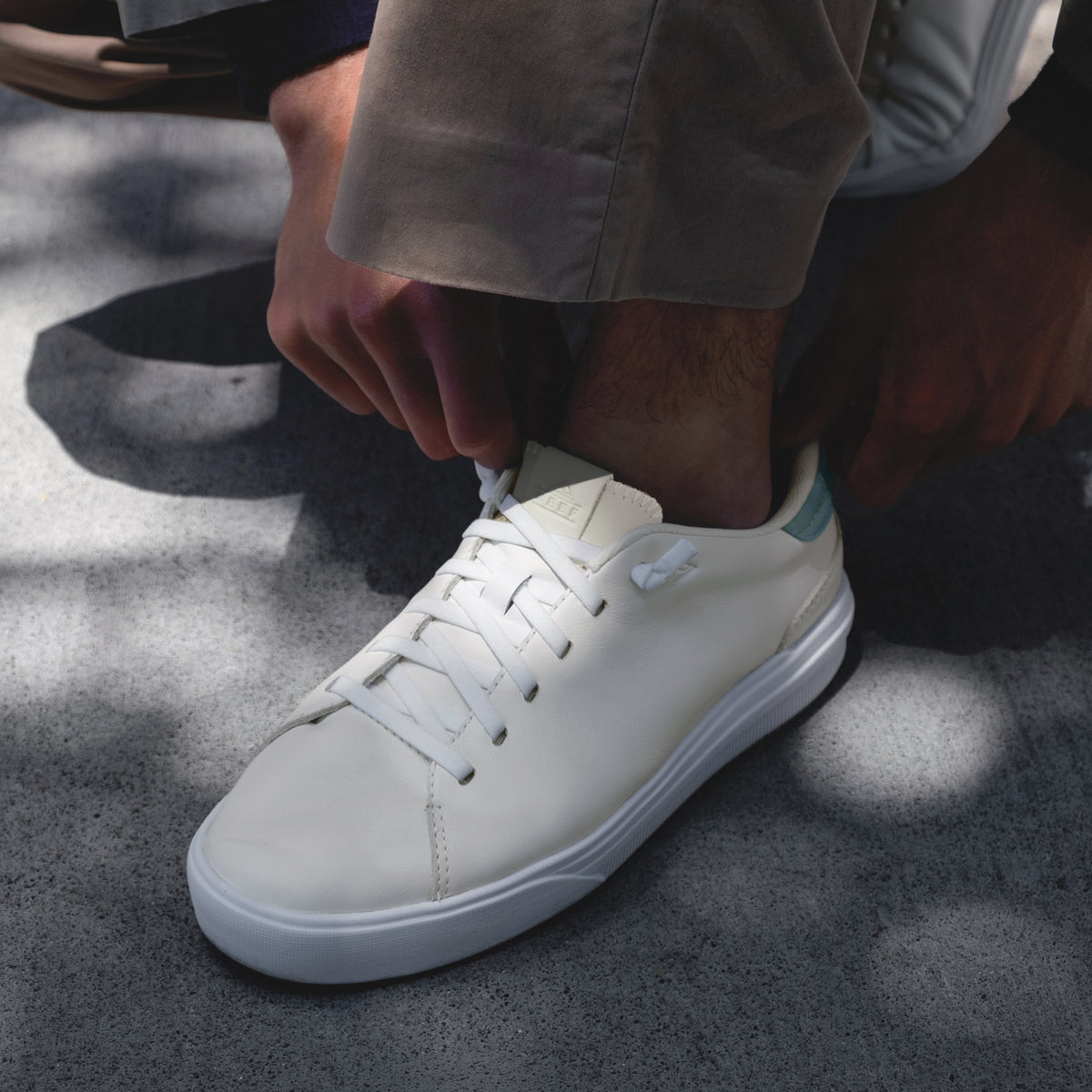 Del Mar Commuter white sneaker facing left in a close up side and top view with cushioned sole