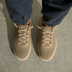 Top view of tan REEF sneakers facing downward with beige laces and breathable mesh toe panels