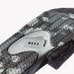 Close-up of underside of Fanning Slide facing down, showing water-friendly camo sole with built-in bottle opener.