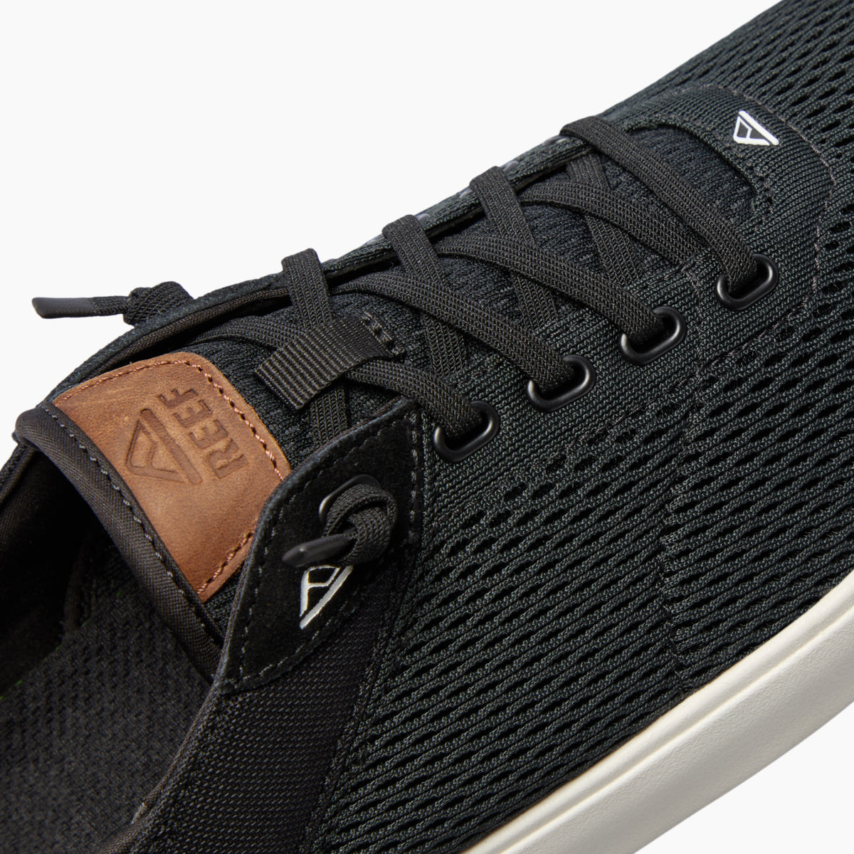 Laguna black sneaker facing left, close-up of breathable upper and lace details