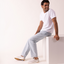 Laguna white sneakers on a seated man, both shoes facing left, offering lightweight comfort for everyday wear