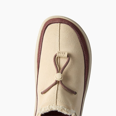 Rambler slipper with toe facing upward, close-up of suede upper and adjustable toggle for cushioned comfort