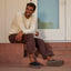 Rambler Mule black mens slip on shoe facing right worn by a seated man with cushioned comfort
