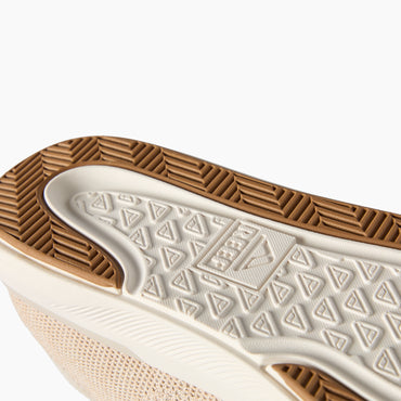 Neptune HT shoe facing sole-up in close-up, showing a cushioned midsole and durable traction tread