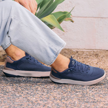 Shoreline Del Mar sneakers on feet facing right, showing mesh uppers, elastic laces, and cushioned soles