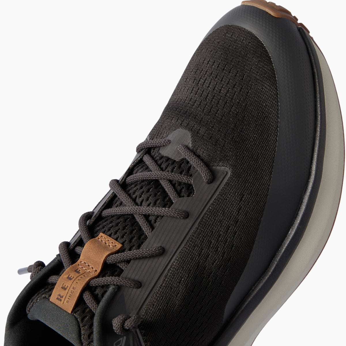 Zuma black sneaker close up facing upper right showing the knit toe and lace up upper