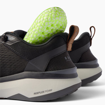 Zuma black sneakers viewed from the rear showing cushioned heels and flexible pull tabs