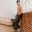 Zuma sneakers facing left on a man indoors, featuring cushioned knit uppers and everyday comfort