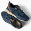 Reef Zuma navy knit sneakers facing upper right and lower left with cushioned soles and flexible heels