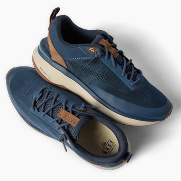 Reef Zuma navy knit sneakers facing upper right and lower left with cushioned soles and flexible heels