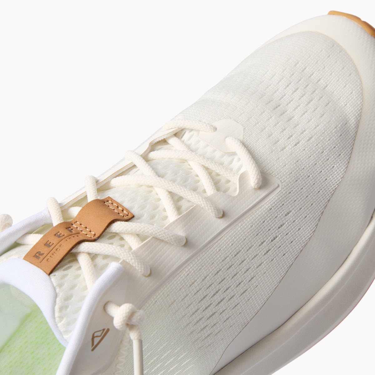Zuma white sneaker close up facing upper right showing the breathable knit upper laces and cushioned sole