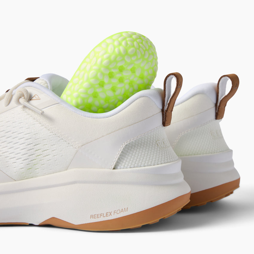 Zuma white knit sneakers, side and heel view facing left, with cushioned soles and pull tabs