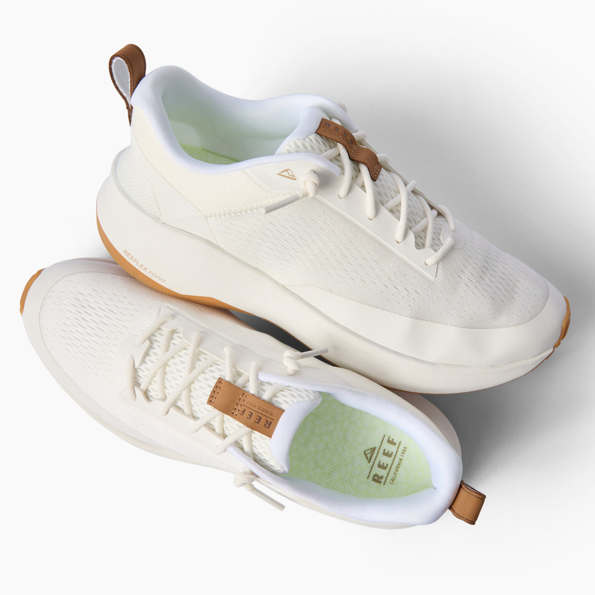 Zuma white sneakers facing right, featuring breathable knit uppers, cushioned soles, and easy pull tabs