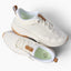 Zuma white sneakers facing right, featuring breathable knit uppers, cushioned soles, and easy pull tabs