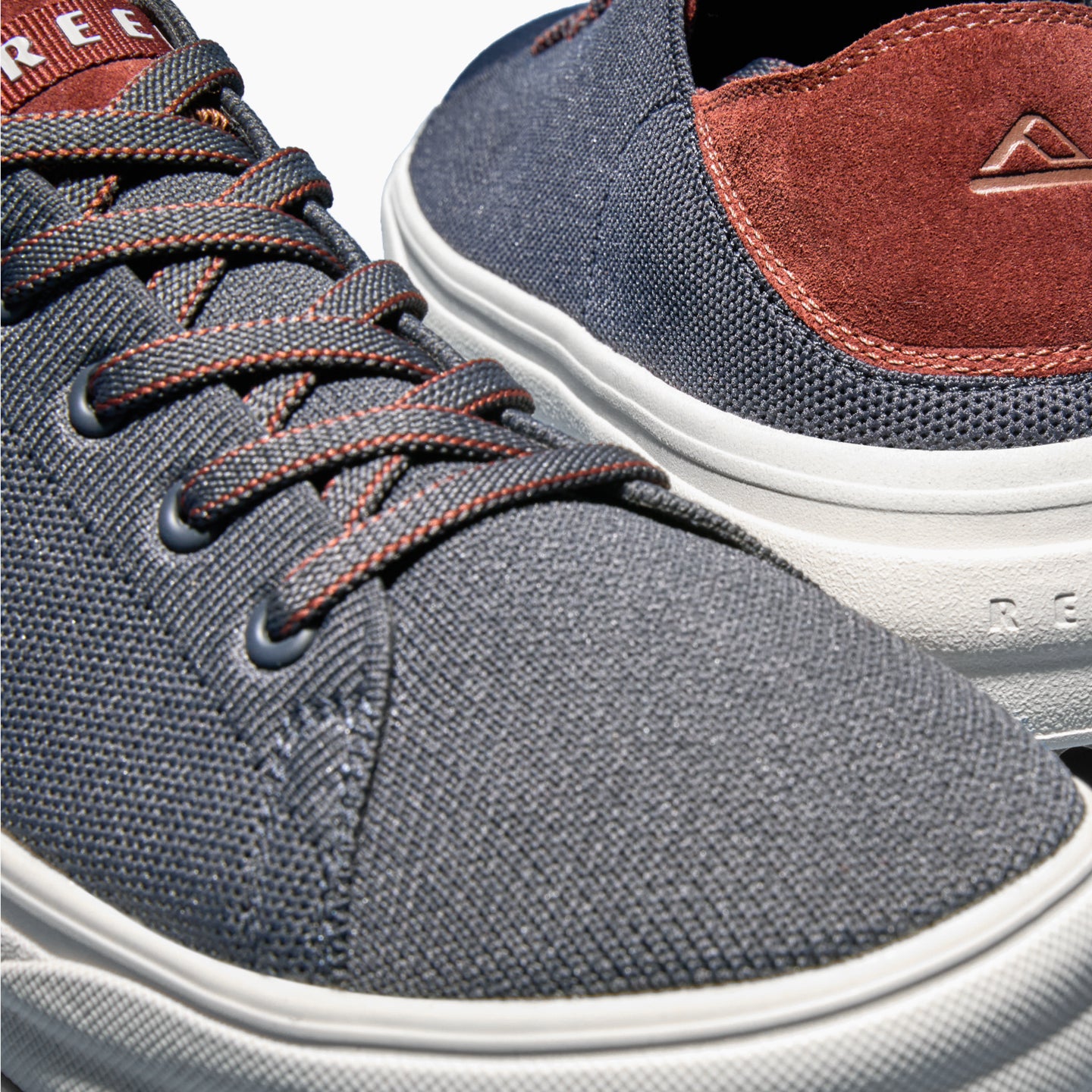 Close-up of the front left and back right of the Atlantic men's shoe in navy with cappuccino accents, designed for comfort.