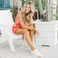 Lay Day Dawn x Jenny shoes facing left on model seated outdoors, showcasing soft-rebound cushioning and arch support