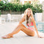 Reef Celine x Jenny sandals facing left on model by poolside, featuring soft scalloped straps and cushioned footbed for beach comfort