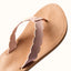 Reef Celine x Jenny sandal close-up of top straps in light peach, featuring scalloped edges and soft cushioning for beach comfort