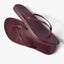 Pair of burgundy Cushion Slim flip flops with slim vegan leather straps shown from top and side angles, right facing sandal on top