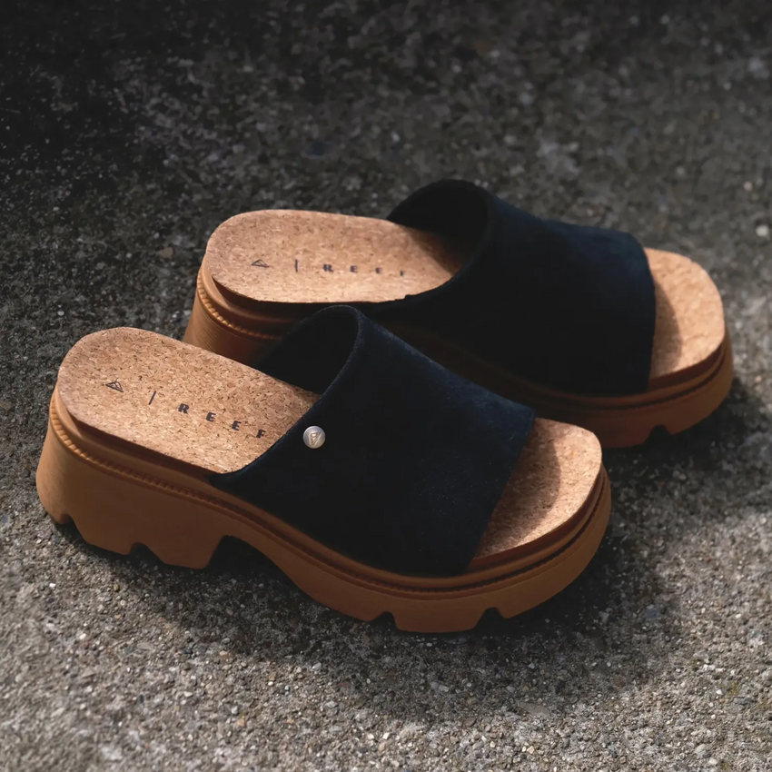 Pair of Vista Luxe Evie sandals facing right, showing black suede upper and cushioned cork footbed with platform sole.
