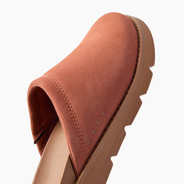 Vista Luxe Mariana suede clog close up facing upper right showing the closed toe and side profile with cushioned comfort sole