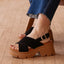 Vista Luxe Ava black suede platform sandal facing left in close up, with crossover straps and an adjustable buckle