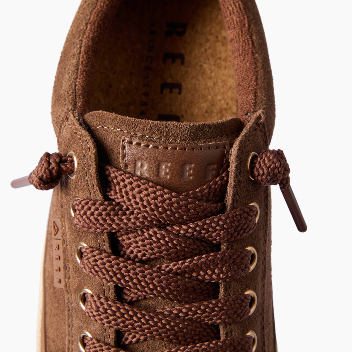 Lay Day Dawn brown sneaker facing forward, close-up of REEF laces and cushioned tongue